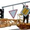 Who carries out the installation of road signs